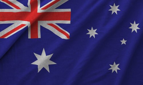 Australia flag depicted on folded wavy fabric of old cloth close up