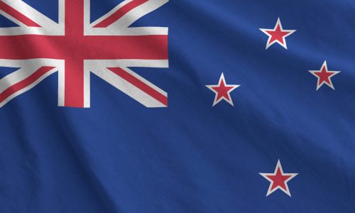 New Zealand flag depicted on folded wavy fabric of old cloth close up